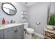 Charming powder room with modern vanity, elegant fixtures, and a decorative mirror at 1824 Clearbrooke Dr, Clearwater, FL 33760