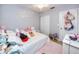 Cozy bedroom featuring playful decor, a soft rug, and ample natural light at 1824 Clearbrooke Dr, Clearwater, FL 33760