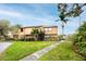 Inviting two-story townhome with a well-manicured lawn and beautiful landscaping at 1824 Clearbrooke Dr, Clearwater, FL 33760