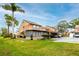 A townhouse featuring an enclosed porch, covered parking, and well-maintained lawn at 1824 Clearbrooke Dr, Clearwater, FL 33760