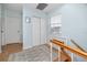 Bright hallway featuring wood floors, white doors, a window, and a closet at 1824 Clearbrooke Dr, Clearwater, FL 33760