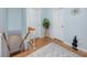 Hallway features wood floors and staircase to lower level, plant, decorative art and a unique violin sculpture at 1824 Clearbrooke Dr, Clearwater, FL 33760