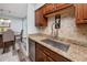 Galley kitchen showcasing granite countertops, stainless steel sink, and modern faucet at 1824 Clearbrooke Dr, Clearwater, FL 33760