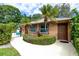 Exterior of pool house with lush landscaping and convenient access gate leading to the community pool area at 1824 Clearbrooke Dr # 1824, Clearwater, FL 33760