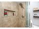 Modern shower with tiled walls, recessed niche, and glass door at 1824 Clearbrooke Dr, Clearwater, FL 33760