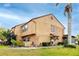 Beautiful two-story home featuring manicured lawn and garden with lush landscaping and charming front entrance at 1824 Clearbrooke Dr, Clearwater, FL 33760