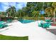 Community swimming pool with turquoise lounge furniture and well-maintained concrete deck area at 1824 Clearbrooke Dr, Clearwater, FL 33760