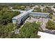 High angle view of a multi-story building nestled among verdant trees, with parking at 2042 Australia W Way # 6, Clearwater, FL 33763
