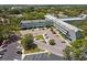 Stunning aerial view of a large building complex surrounded by lush greenery and ample parking at 2042 Australia W Way # 6, Clearwater, FL 33763