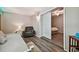 Bedroom with a gray armchair, a futon and a view into another bedroom through white sliding doors at 2042 Australia W Way # 6, Clearwater, FL 33763