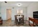Dining area with wood-look flooring and a view of the bright kitchen through a pass-through window at 2042 Australia W Way # 6, Clearwater, FL 33763