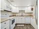 Well-maintained kitchen with white cabinets, stainless steel appliances, and neutral granite countertops at 2042 Australia W Way # 6, Clearwater, FL 33763