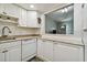Bright kitchen featuring white cabinets, granite countertops, and stainless steel faucet at 2042 Australia W Way # 6, Clearwater, FL 33763