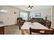 Well-lit living room with wood-look floors, open layout to dining area, and large windows at 2042 Australia W Way # 6, Clearwater, FL 33763