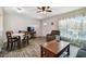 Open-concept living and dining room area features dark wood-look floors and abundant natural light at 2042 Australia W Way # 6, Clearwater, FL 33763