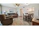 Comfortable living room with wood-look floors, open layout to dining area, and neutral color palette at 2042 Australia W Way # 6, Clearwater, FL 33763