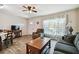 Cozy living room with a ceiling fan, wood-look flooring, and a large window for natural light at 2042 Australia W Way # 6, Clearwater, FL 33763