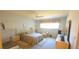 Bright bedroom featuring white walls, neutral carpet, and a coordinated bed and furniture set at 2222 Norwegian Dr # 24, Clearwater, FL 33763