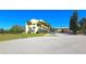 Exterior view of a multi-story building with palm trees and a well-maintained lawn at 2222 Norwegian Dr # 24, Clearwater, FL 33763