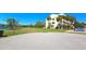 Exterior view of a multi-story building with palm trees and a well-maintained lawn at 2222 Norwegian Dr # 24, Clearwater, FL 33763
