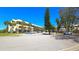 Attractive exterior view of a multi-story building featuring palm trees and parking spaces at 2222 Norwegian Dr # 24, Clearwater, FL 33763