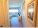 Hallway view into a bedroom with neutral carpet and an open door at 2222 Norwegian Dr # 24, Clearwater, FL 33763