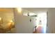 Hallway with wood floors, nautical décor and bright lighting offer a calming welcome at 2222 Norwegian Dr # 24, Clearwater, FL 33763