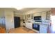 Well-lit kitchen featuring white cabinets and modern black appliances at 2222 Norwegian Dr # 24, Clearwater, FL 33763