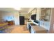 Bright kitchen features white cabinets with black appliances and cozy dining area at 2222 Norwegian Dr # 24, Clearwater, FL 33763