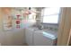 Laundry room featuring a washer, dryer, shelves, and a bright window at 2222 Norwegian Dr # 24, Clearwater, FL 33763