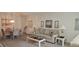 Bright living room offering a cozy sofa and adjacent dining space at 2222 Norwegian Dr # 24, Clearwater, FL 33763