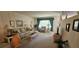 Bright living room featuring comfortable seating, natural light, and carpet flooring throughout at 2222 Norwegian Dr # 24, Clearwater, FL 33763