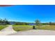 Scenic view of an outdoor park with a paved walkway, lush greenery, and water at 2222 Norwegian Dr # 24, Clearwater, FL 33763