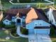 Stunning aerial view of home with mature landscaping, a backyard pool, and fenced yard at 2233 Golf Manor Blvd, Valrico, FL 33596