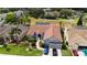 Aerial view of blue house with brick roof, landscaped front yard, and cars in the driveway at 2233 Golf Manor Blvd, Valrico, FL 33596