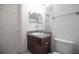 Small bathroom with a vanity, mirror, and a toilet; clean and functional at 2233 Golf Manor Blvd, Valrico, FL 33596