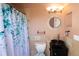 Well-appointed bathroom featuring stylish fixtures, a unique vessel sink, and a decorative shower curtain at 2233 Golf Manor Blvd, Valrico, FL 33596