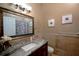 Cozy bathroom featuring a granite countertop, a decorative mirror, and a shower with floral curtains at 2233 Golf Manor Blvd, Valrico, FL 33596