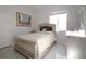 Well-lit bedroom with a large window, stylish furniture, and neutral color palette at 2233 Golf Manor Blvd, Valrico, FL 33596