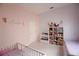Charming bedroom decorated with a pastel color palette, white tiled floor, and ample toy storage at 2233 Golf Manor Blvd, Valrico, FL 33596