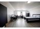 Spacious bedroom featuring two windows, a black accent wall, and light wood laminate flooring at 2233 Golf Manor Blvd, Valrico, FL 33596