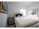 Cozy bedroom featuring a window, a double bed, modern fixtures, and a chest of drawers at 2233 Golf Manor Blvd, Valrico, FL 33596