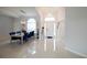 Bright foyer with porcelain tile floors and elegant chandelier, showcasing dining area at 2233 Golf Manor Blvd, Valrico, FL 33596