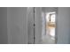 Hallway view of bathroom with soaking tub and decorative chandelier at 2233 Golf Manor Blvd, Valrico, FL 33596