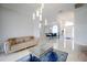 Bright living room with elegant decor, modern lighting, and open access to the dining area at 2233 Golf Manor Blvd, Valrico, FL 33596