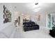 Open living area showcasing modern decor, white tile flooring, and seamless flow to the kitchen and dining spaces at 2233 Golf Manor Blvd, Valrico, FL 33596