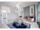 Modern living room featuring stylish decor, statement lighting, and porcelain tile flooring at 2233 Golf Manor Blvd, Valrico, FL 33596