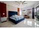 Main bedroom featuring large windows, a fan, a couch, and modern decor elements at 2233 Golf Manor Blvd, Valrico, FL 33596