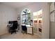 Bright home office with a large arched window, built-in shelving, and a contemporary desk setup at 2233 Golf Manor Blvd, Valrico, FL 33596