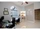 Home office with a decorative brick accent wall, two work stations, and illuminated shelving at 2233 Golf Manor Blvd, Valrico, FL 33596